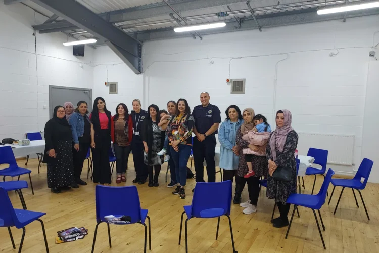 Group photo taken during a coffee morning with the Kurdish community.