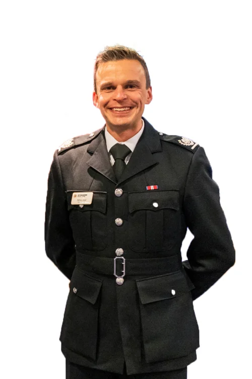 Damien West in undress uniform with a white background.