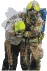 Firefighter carring a casualty with a smoke mask on