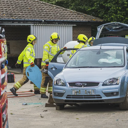 Trainee firefighters practising their response to a road traffic collision