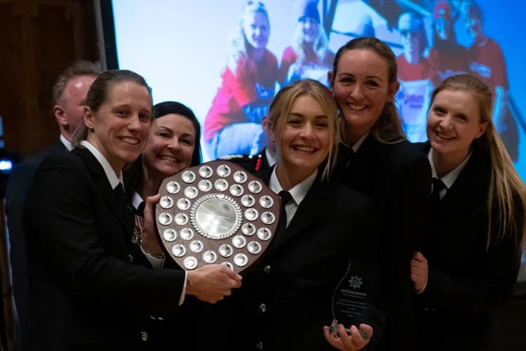 Five members of the Toubkal climb team smile and pose with the Frank Swann fundraising shield.