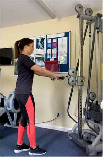 Standing row exercise with arms stretched out