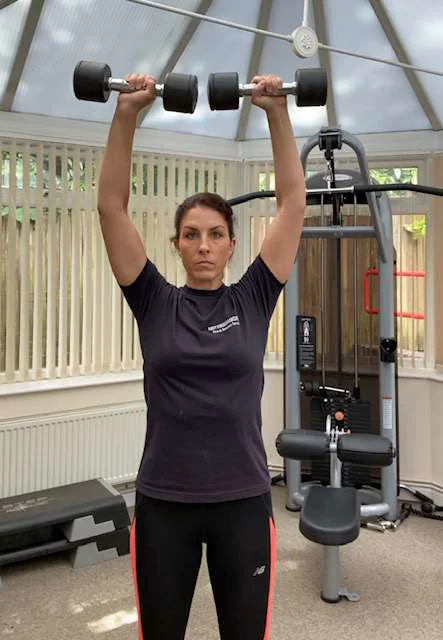 Overhead press using dumbbells