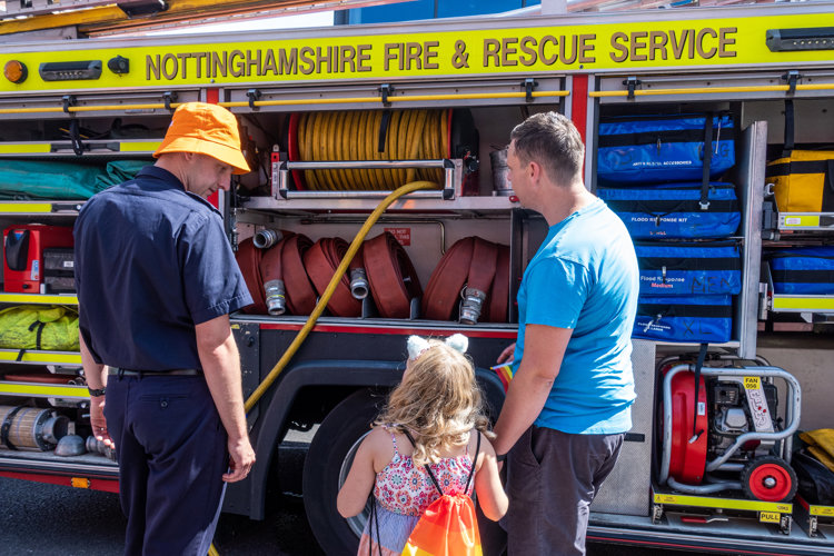 Firefighter showing a family around a fire engine during Worksop Pride