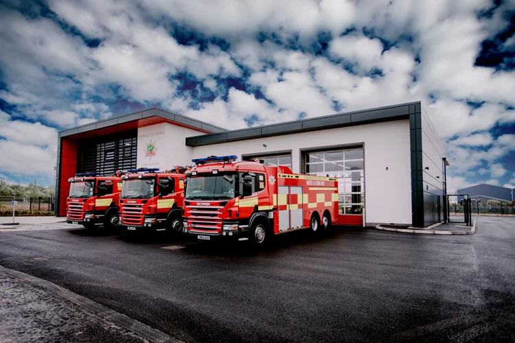 Front of Worksop Fire Station with two fire engines and a water bowsers parked outside