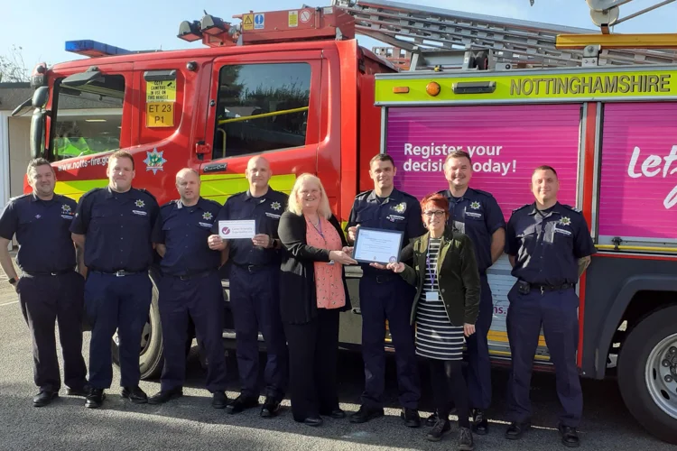 Firefighters from Stapleford gather with their certificate with staff from Notts Carers Association
