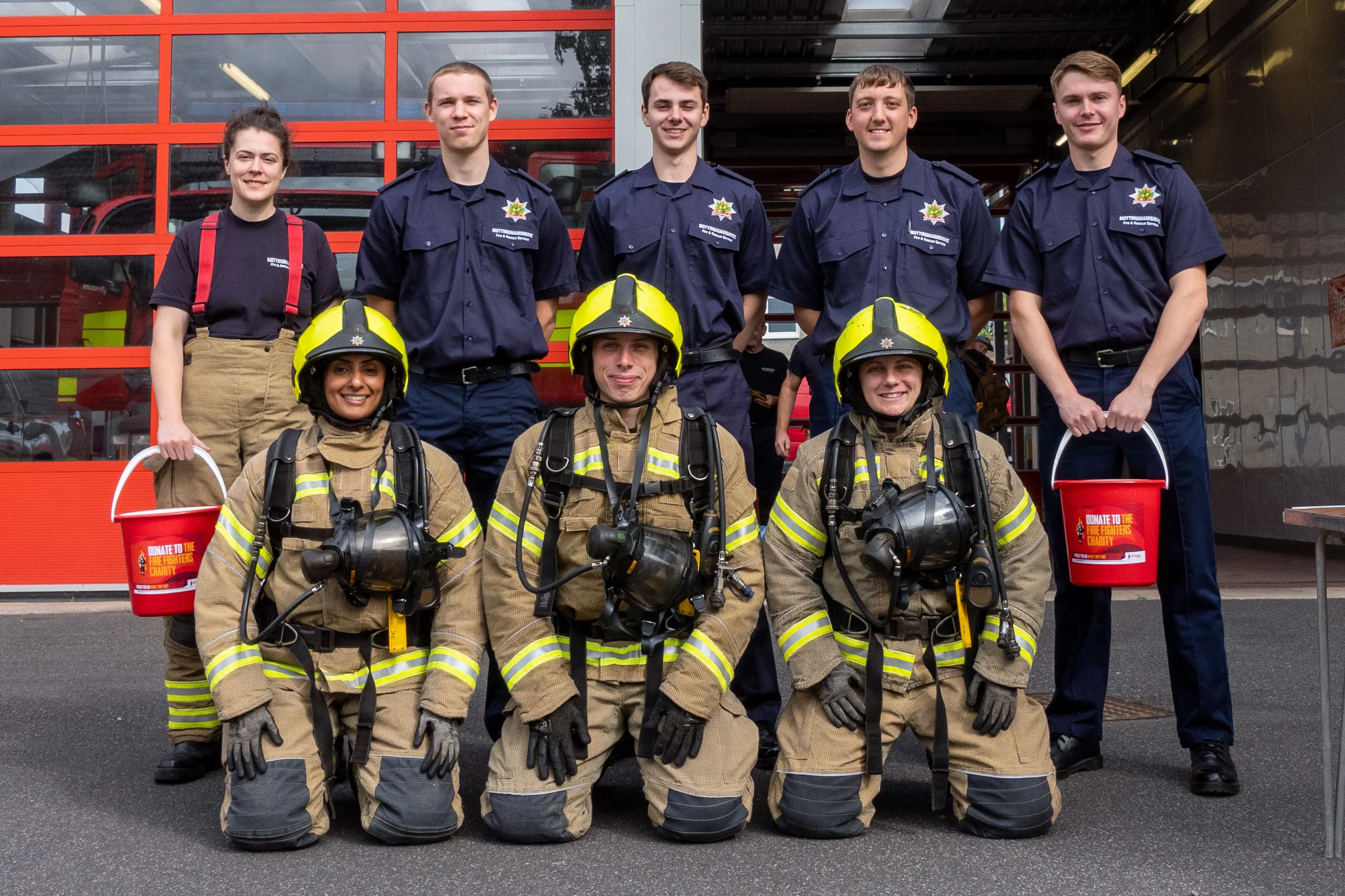 Photo of group of firefighters in fire kit ready for a charity event