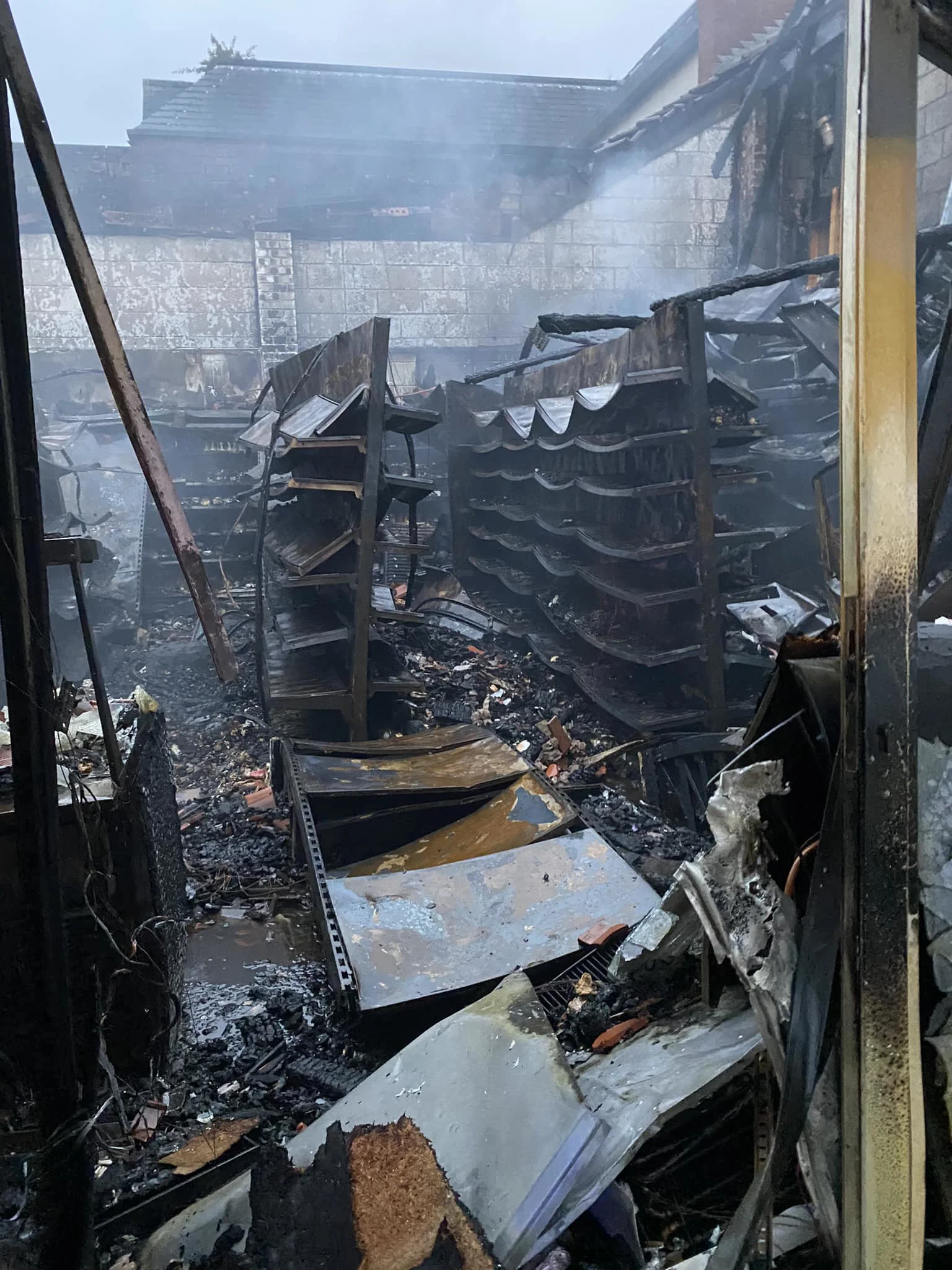 fire damaged building showing burnt shelving