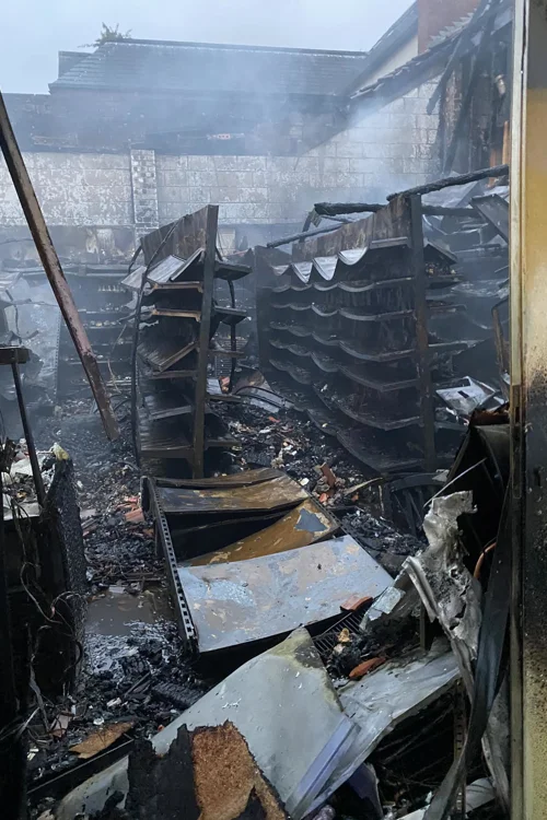 fire damaged building showing burnt shelving