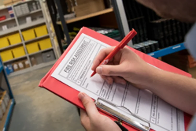 Clipboard with a fire risk assessment being filled out