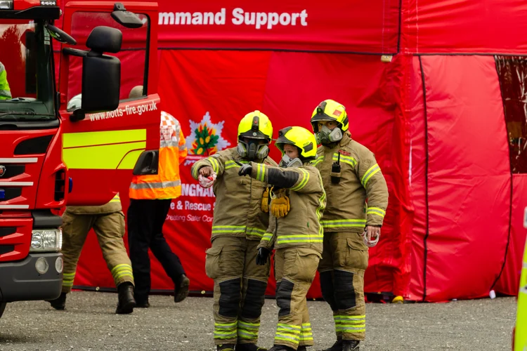 Firefighters in masks pointing