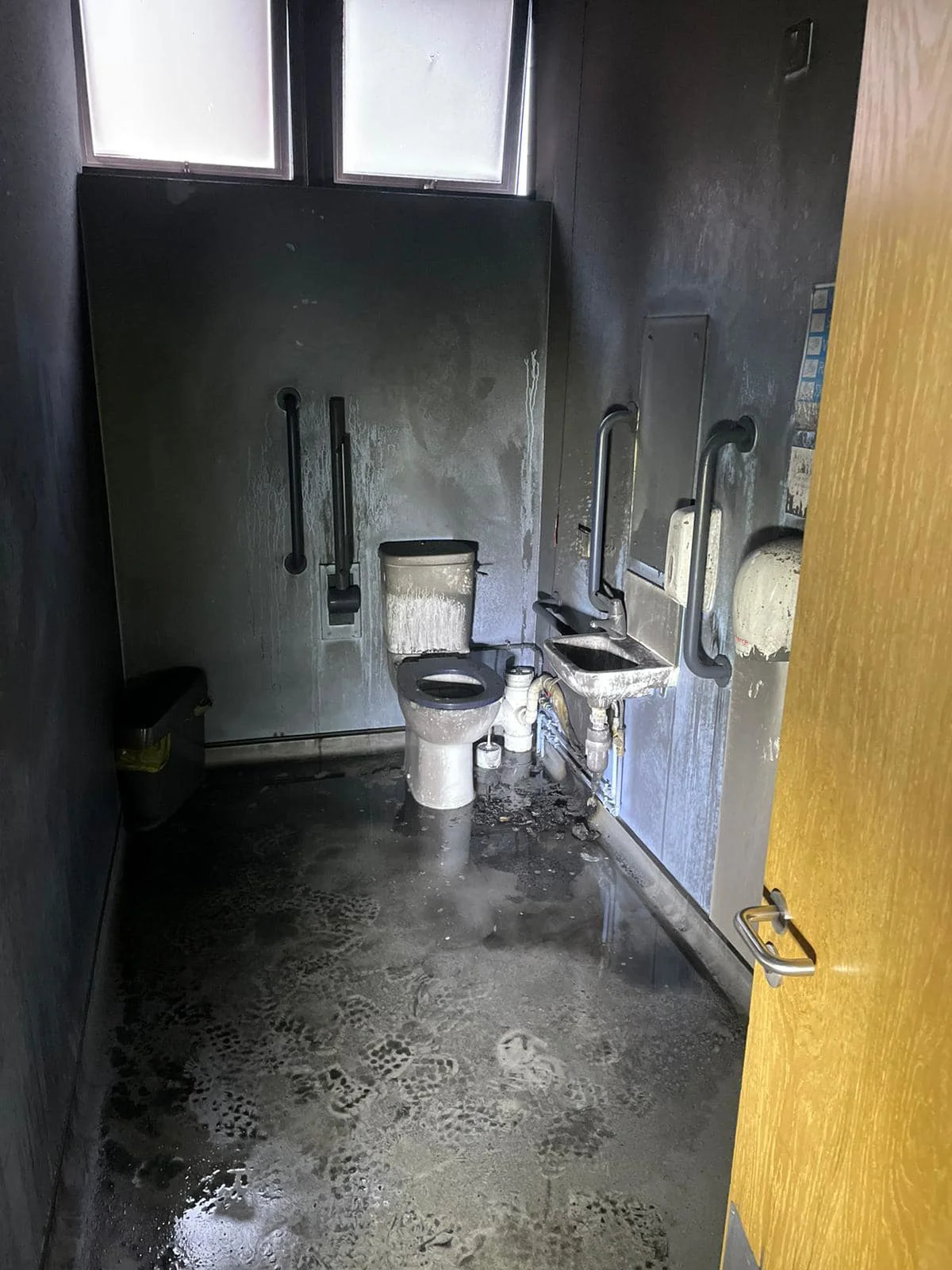 photo of a toilet cubicle that has been damaged by fire