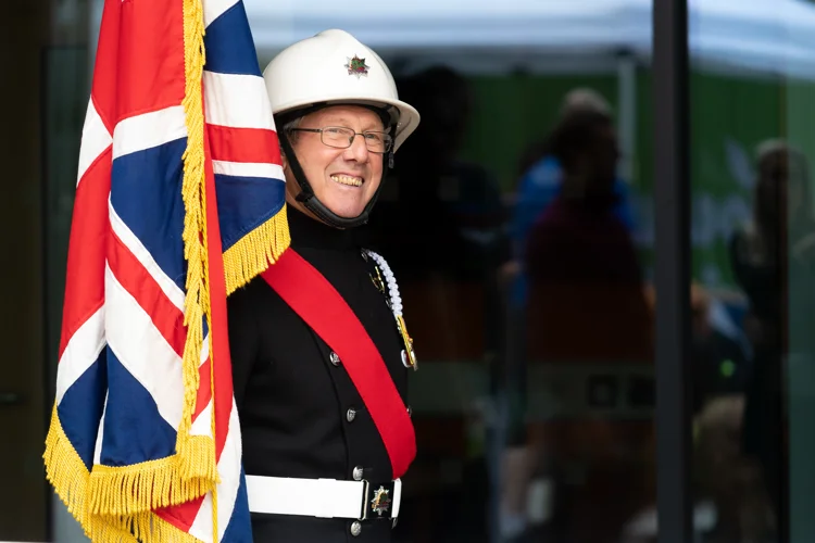 Fire Service ceremonial squad member holding the Union Flag