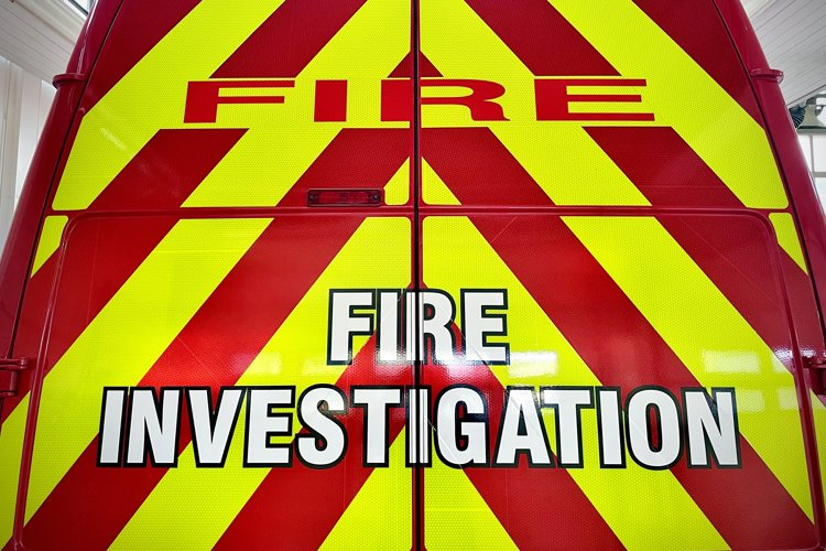 Back of the Fire Investigation van with "FIRE INVESTIGATION" written on it.