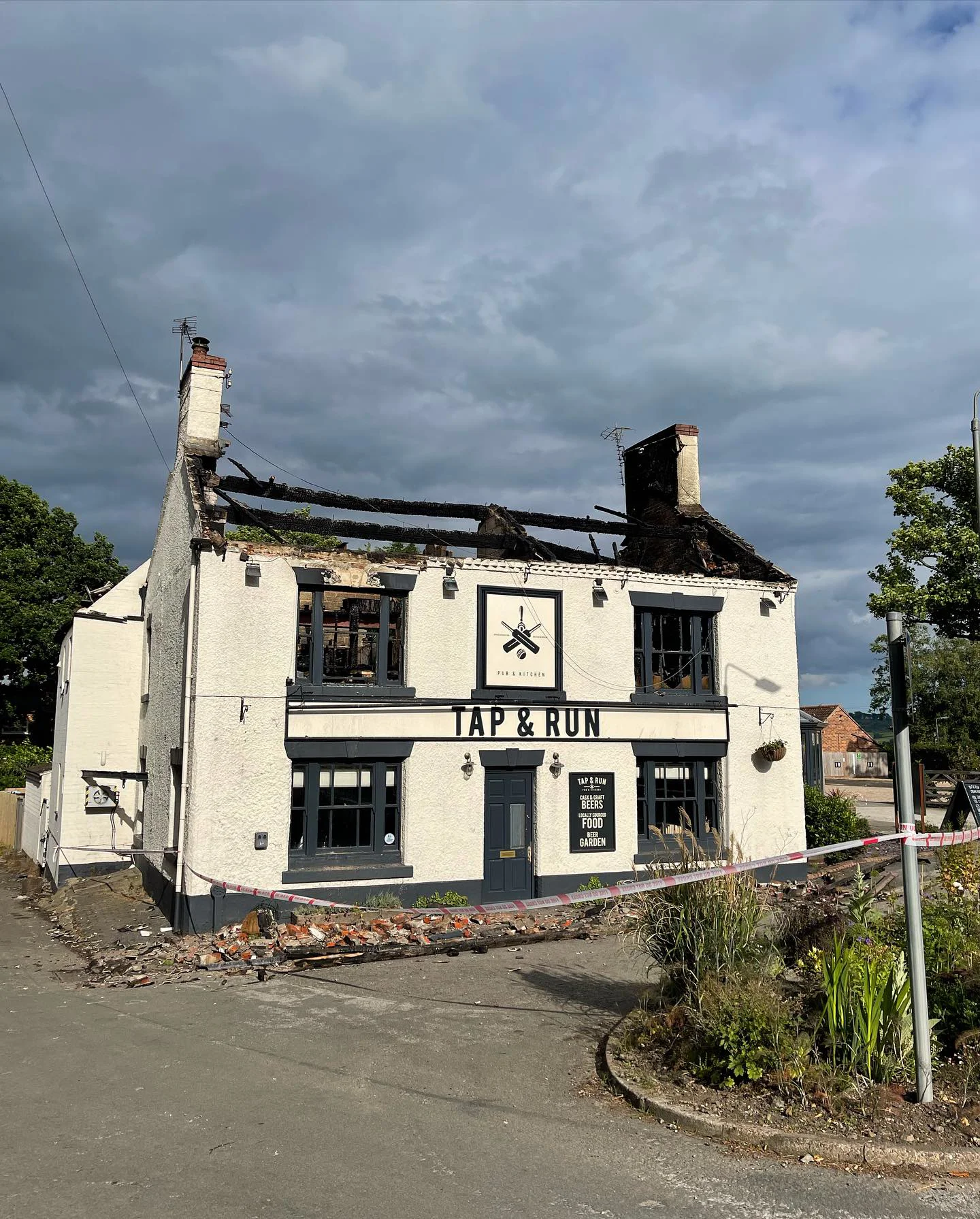 Tap and Run pub from the outside showing the fire and serious damage to the roof