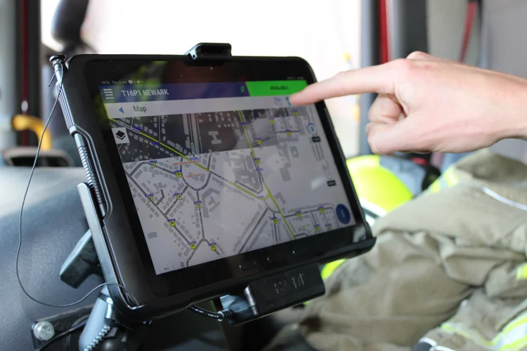 A hand pressing a mobile data terminal (MDT)