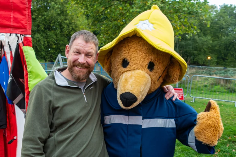 former Chief John Buckley stands with Blaze Bear