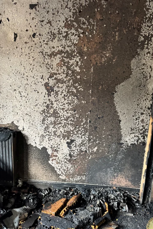 Room and wall damaged by fire