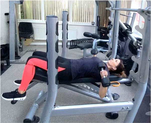 Example of a bench press in the down position using dumbbells