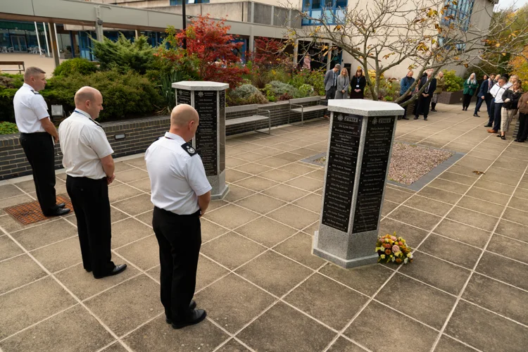 Police and Fire colleagues taking part in a two minute silence for emergency services day 2022