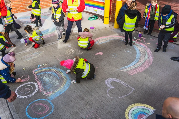 School children decorate the forecourt of Newark Fire Station with rainbows, love hearts and smoke alarms.