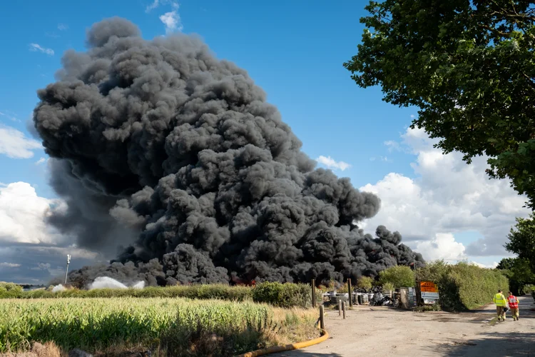 Large fire with thick black smoke coming from it