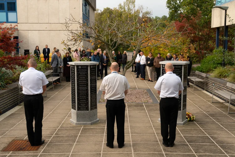 Police and Fire colleagues taking part in a two minute silence for emergency services day 2022