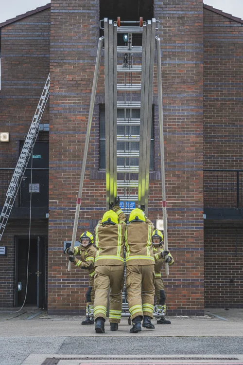 Recruits practising putting up a 13.5m ladder