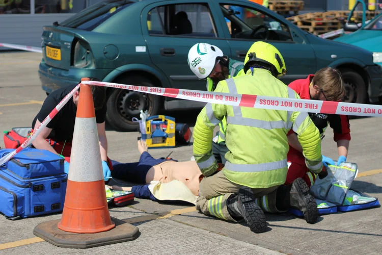 A firefighter, paramedic and doctor treat a training casualty