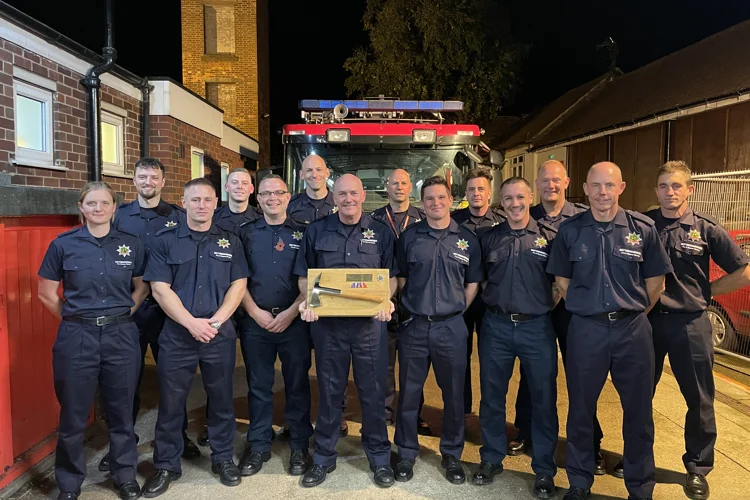 Firefighters from Bingham in front of the fire engine with FF Andrew Mumford holding a silver axe