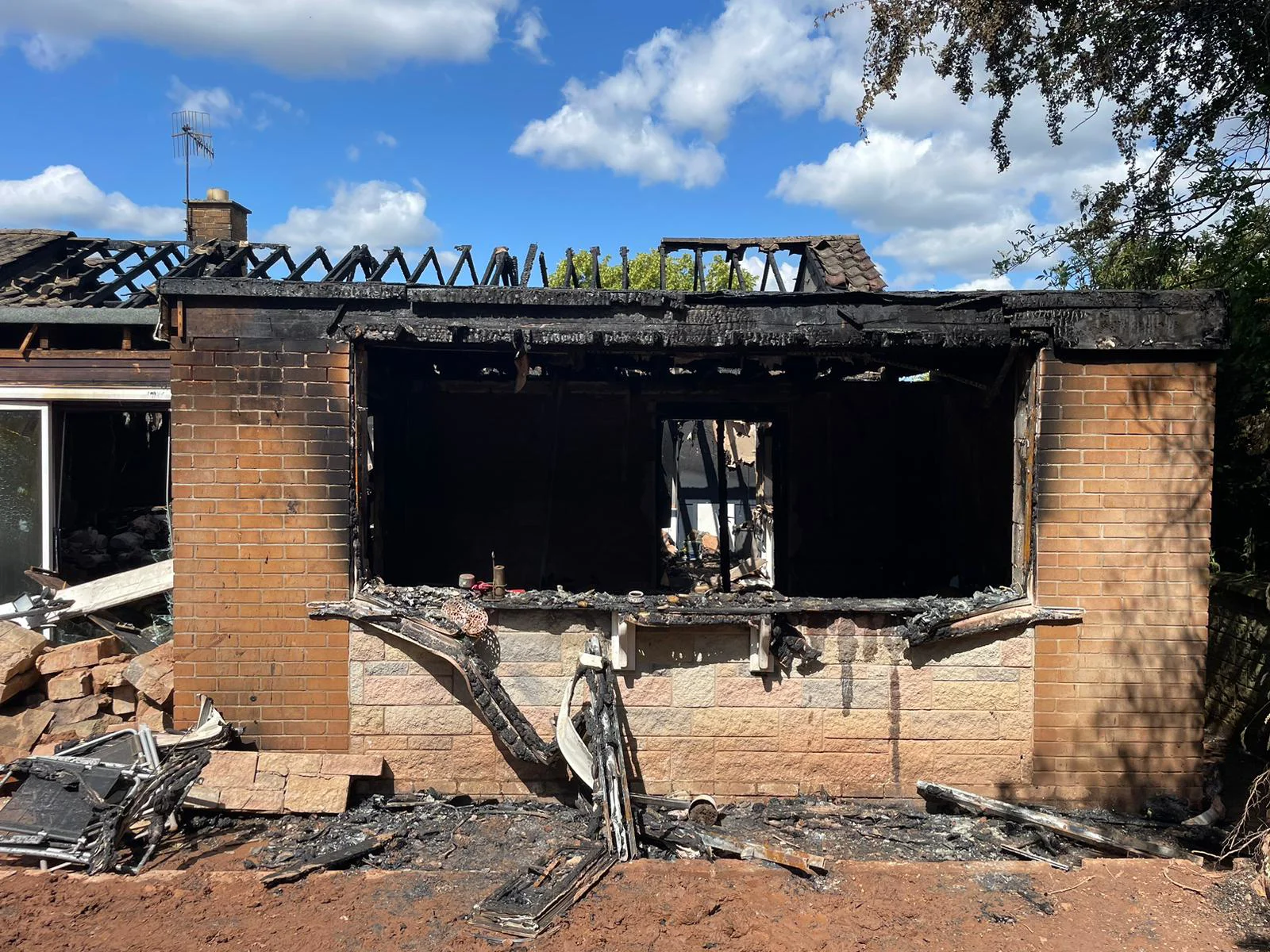 View from outside the bungalow where fire damage is visible