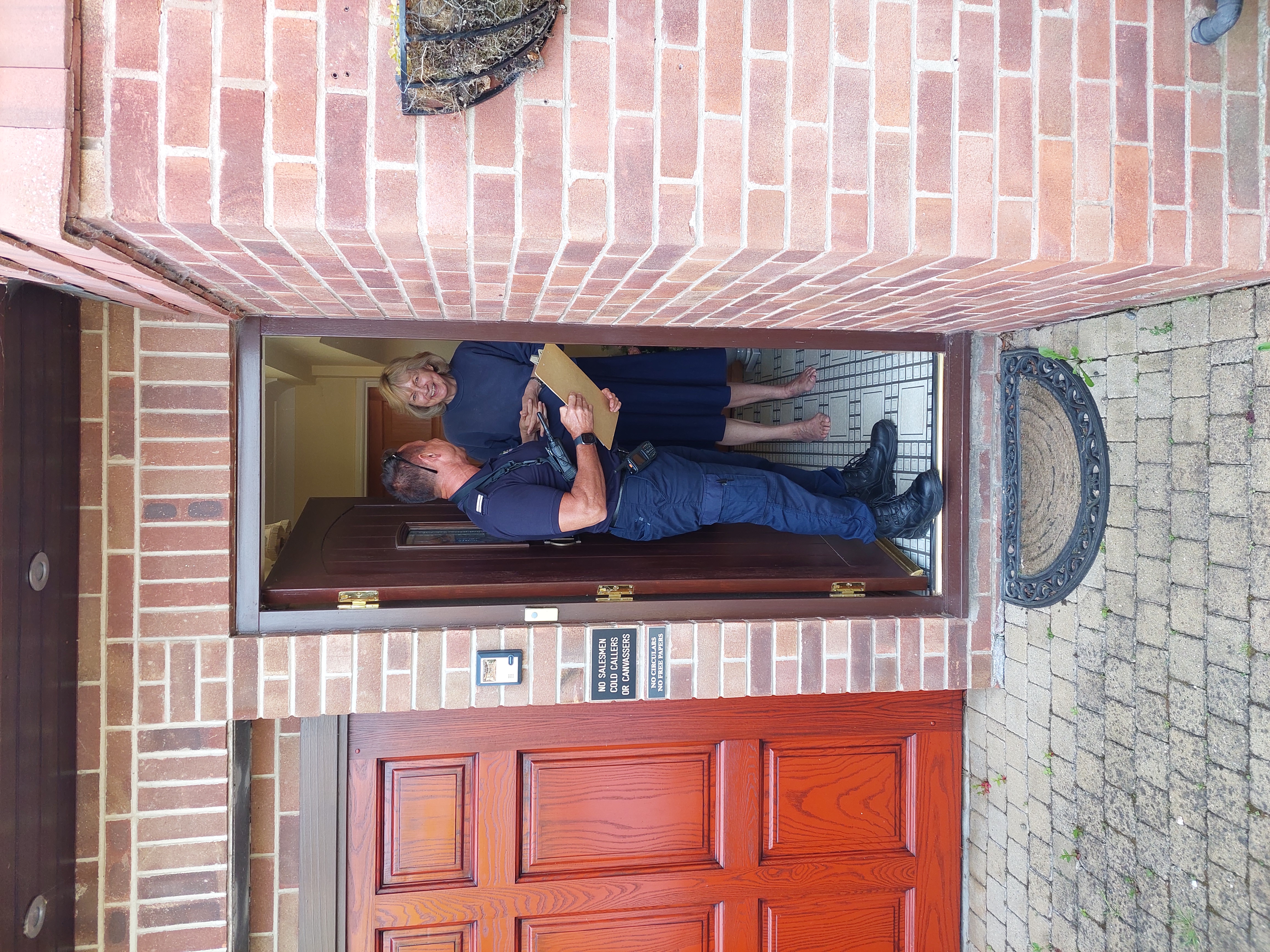 Firefighter speaks to local residents on their doorstep about the recent fire in Sutton Bonington