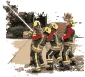 Firefighter giving instruction to young adults on how to use a fire hose
