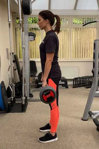 Deadlift using a bar bell in the up standing position