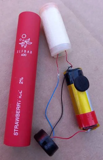 single use e-cigarette that has been dismantled, showing contents of cylinder