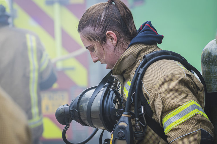 Firefighter in full breathing apparatus after a training exercise
