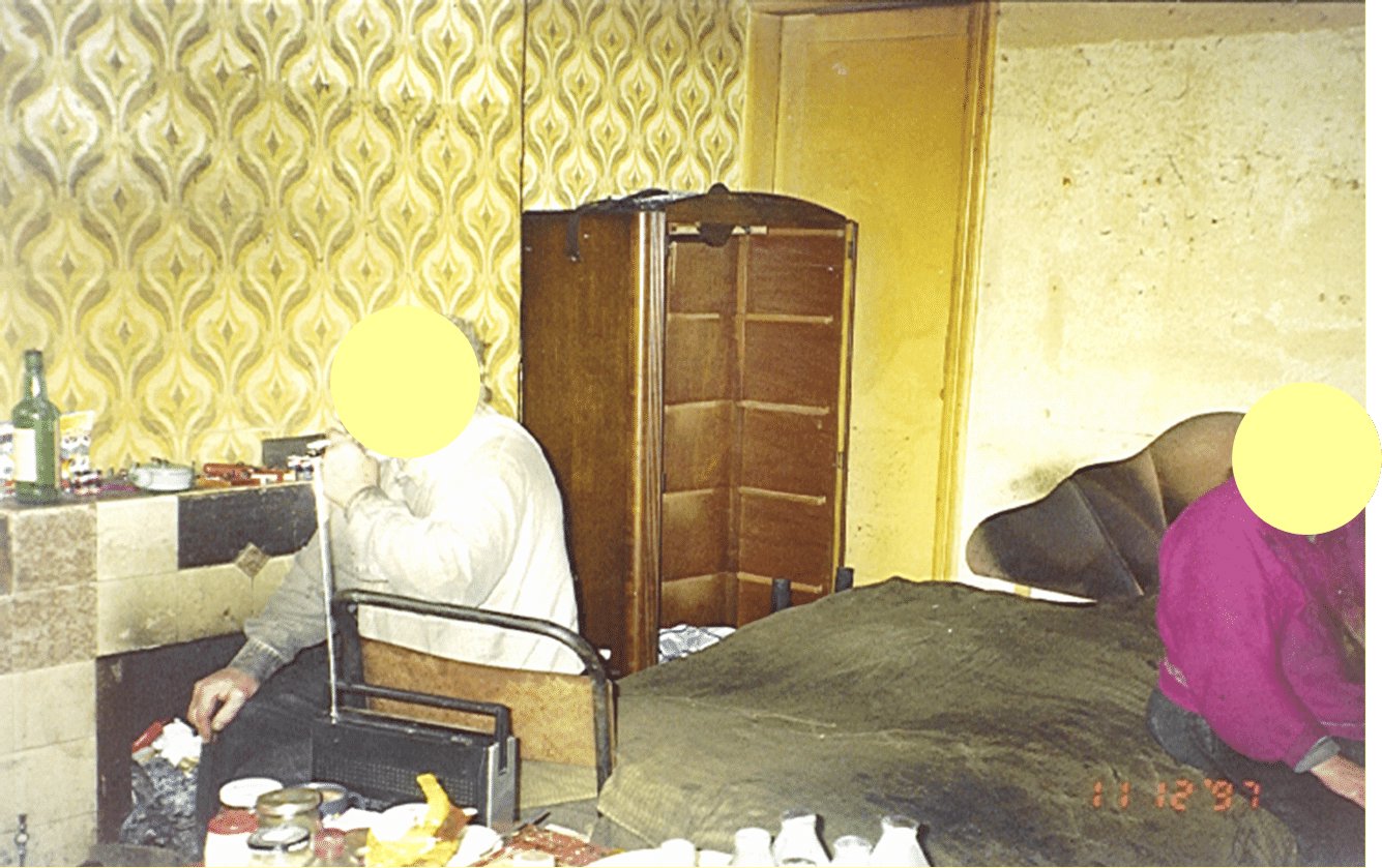 Elderly couple in their bedroom, their faces have been covered up.
