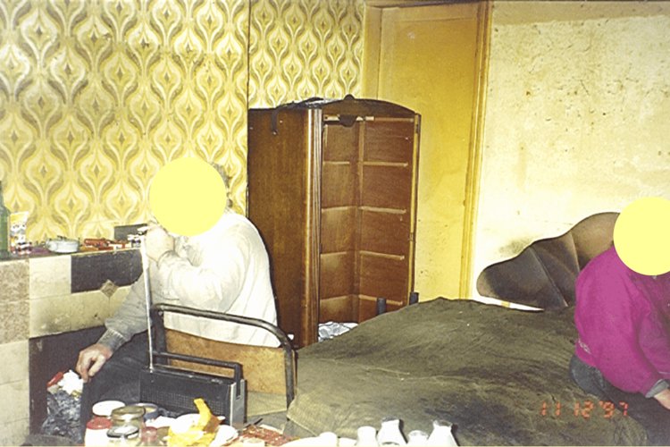 Elderly couple in their bedroom, their faces have been covered up.