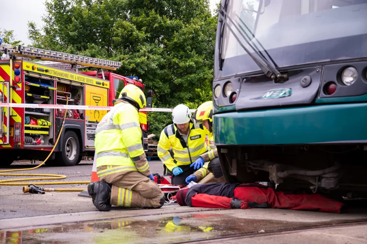 Firefighters training how to extract a casualty trapped under a tram