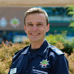 Damien West in his blue uniform as Assistant Chief Fire Officer
