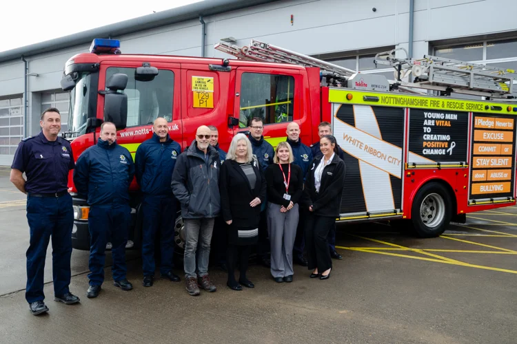 Highfields Fire Engine with new White Ribbon wrapping on. In front is a crew of firefighters from Highfields and White Ribbon ambassadors