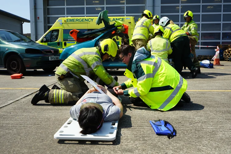A firefighter and paramedic work on a training casualty.