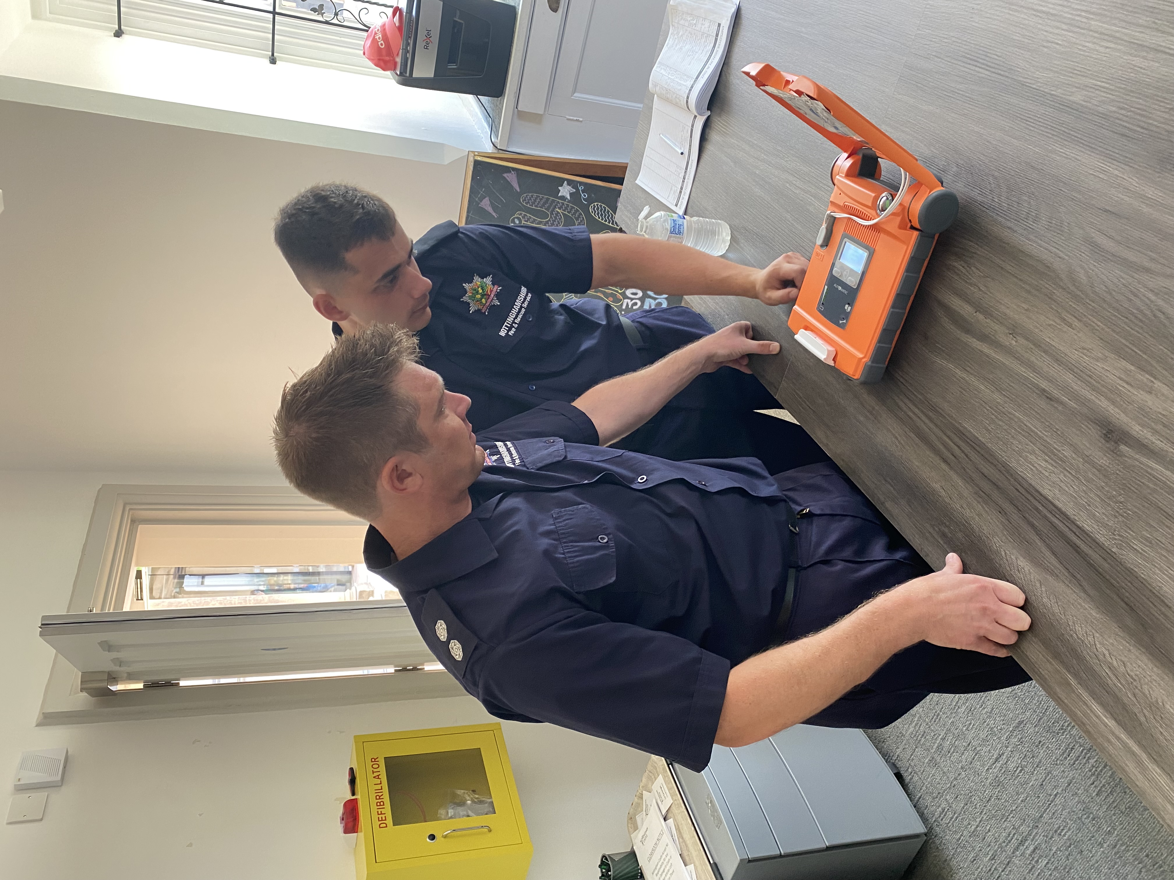 Firefighters training with a defibrillator