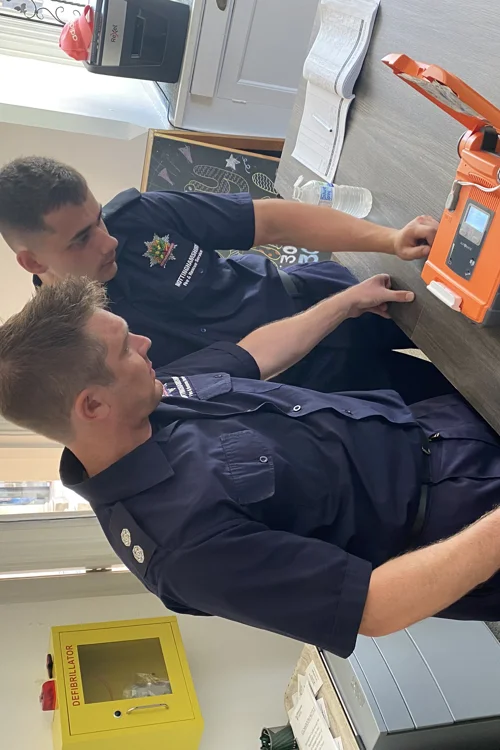 Firefighters training with a defibrillator