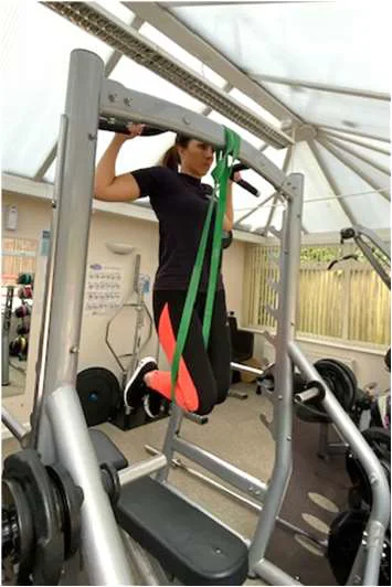 Demonstration of a pull up using an exercise band for assistance in the up position
