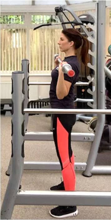 Overhead press viewed from the side with bar at shoulder height