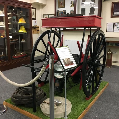 Display at the Mansfield Fire Museum showing a cart that was used to carry fire hose.