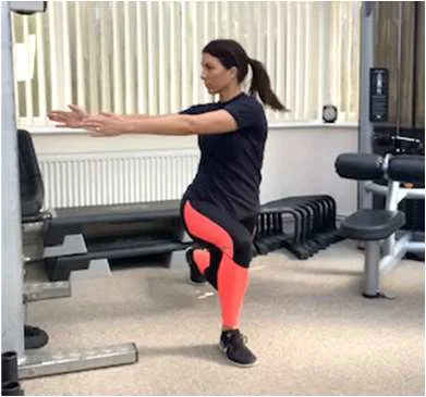 A women performing a lunge with both arms extended and her upper body twisted to her right