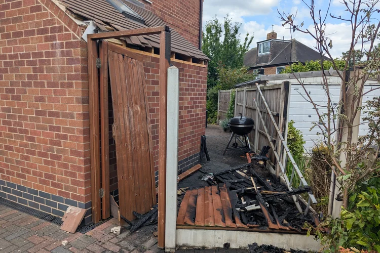 Fire damage to fence caused by BBQ