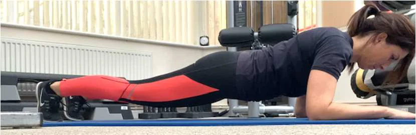 A women demonstrating how to perform a plank